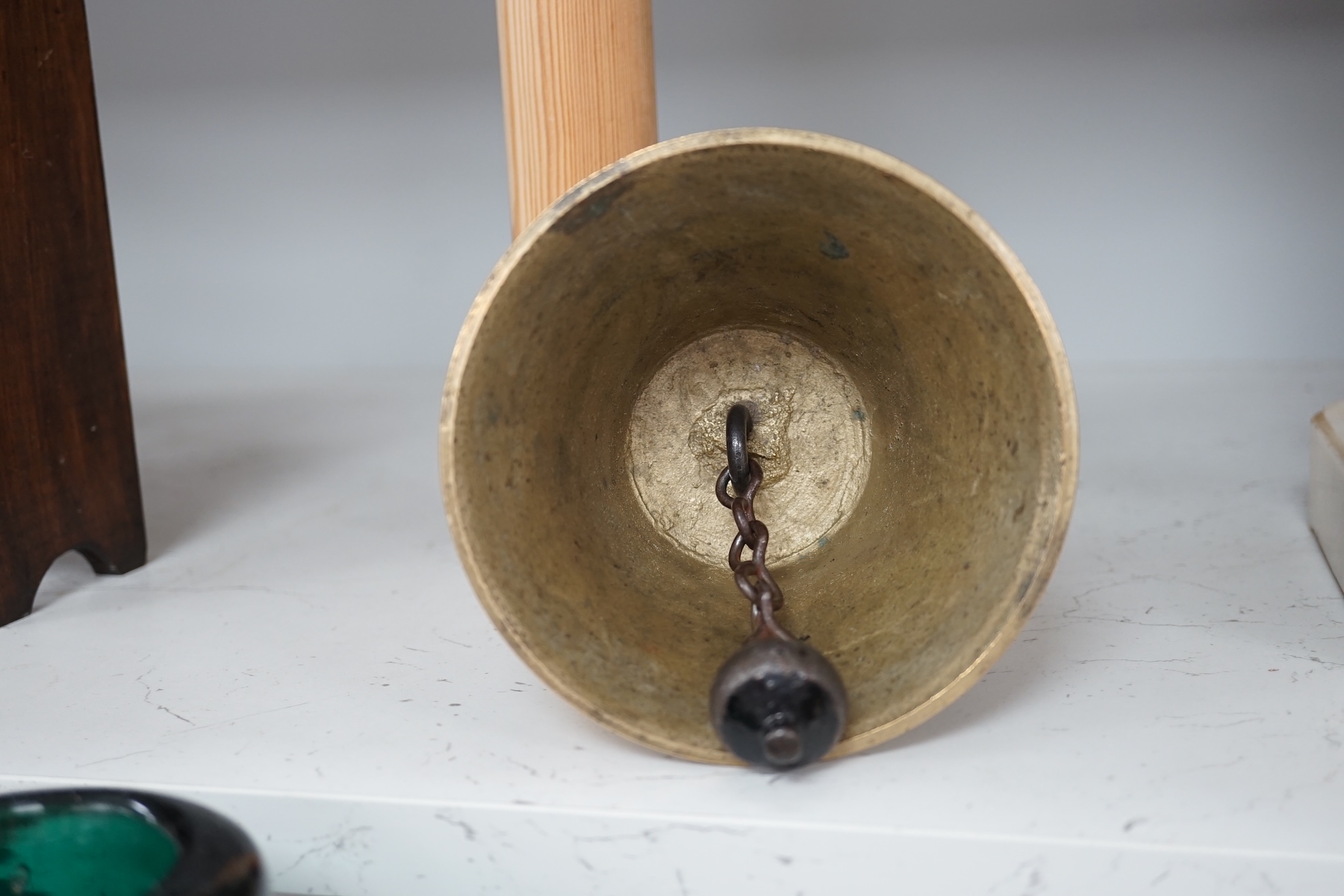 A late 19th/early 20th century brass school bell, with a turned mahogany handle, bell diameter 12.5cm, height 26cm. Condition - fair to good.